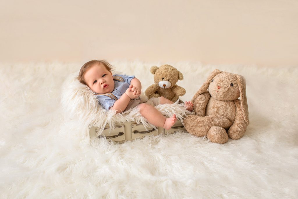 3 month baby pictures khaki shorts button up collared shirt suspenders with favorite teddy bear eyes to camera