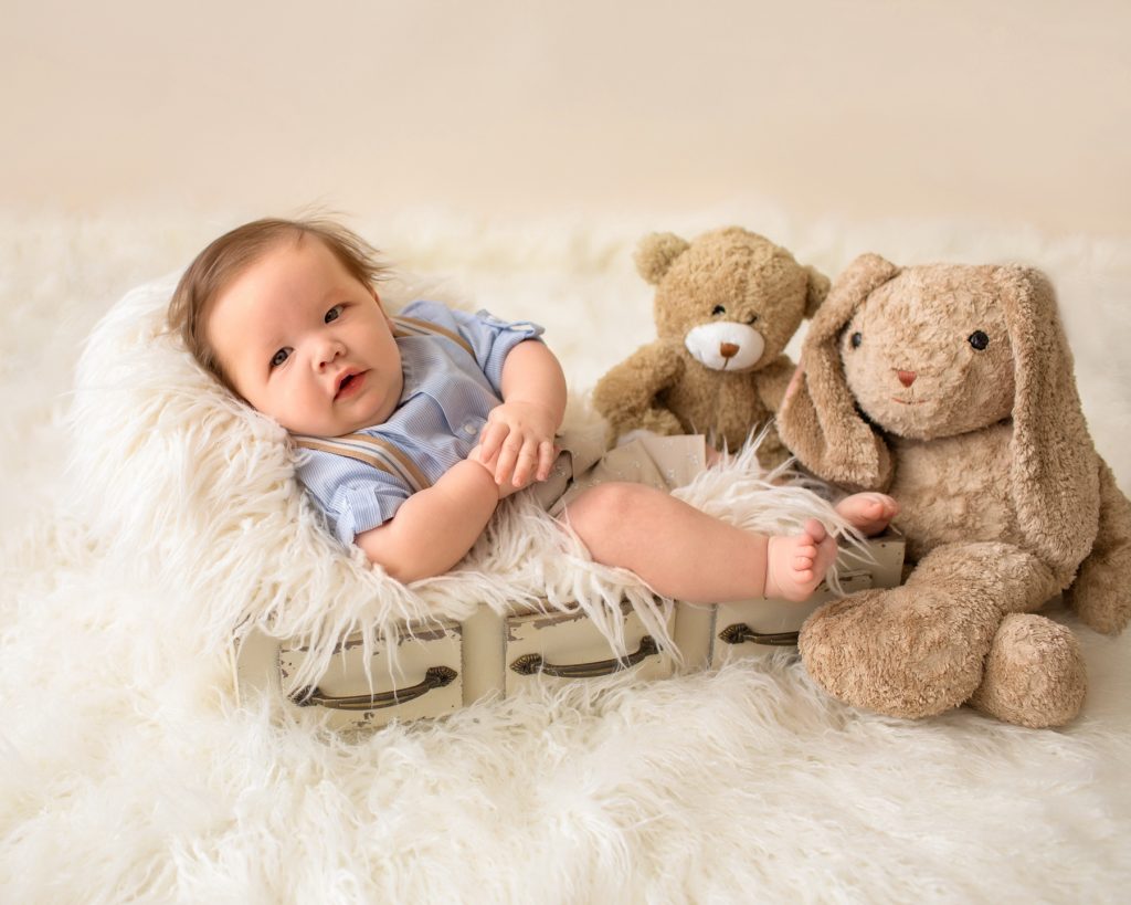 3 month baby pictures khaki shorts button up collared shirt suspenders teddy bear mom's stuffed bunny little baby grin