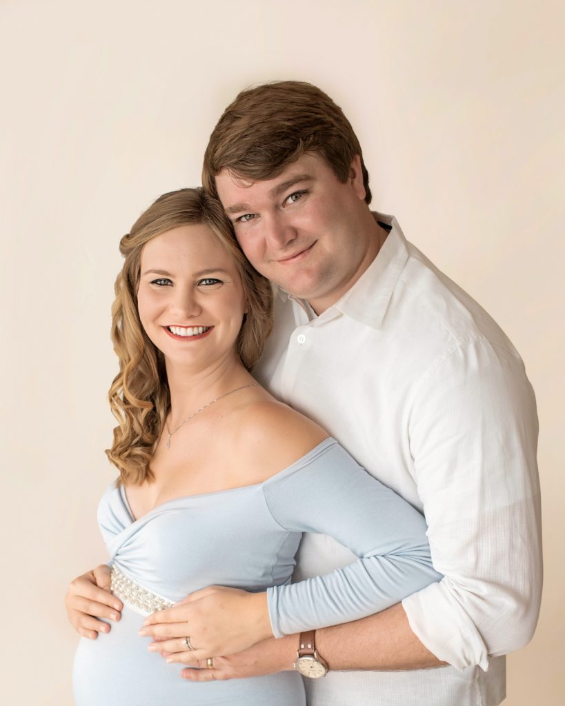 Gorgeous new mom long blond curls in long sleeve baby blue maternity gown pearl bodice sash with handsome dad