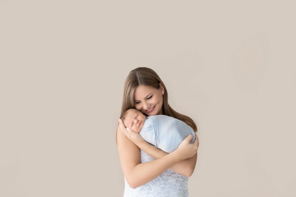 Delighted new mom snuggles baby boy Gabe newborn photography