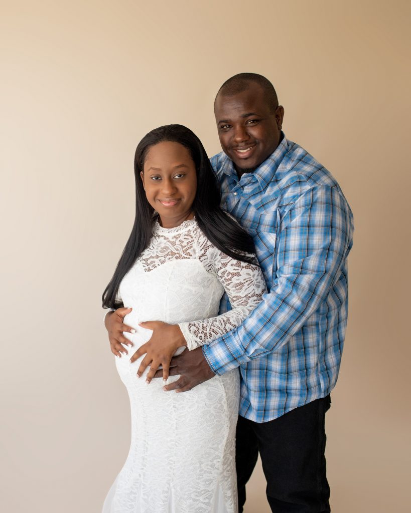 christine white lace maternity gown expectant mama poses with husband