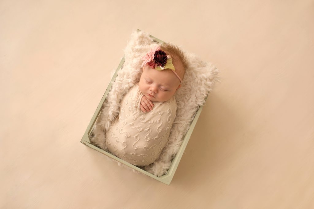 newborn photo session girl ivory lace in sea green wooden crate floral headtie Gainesville FL