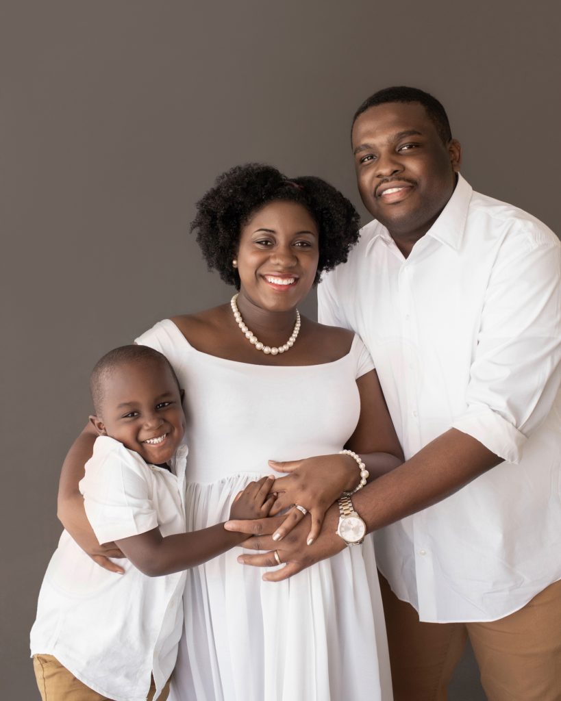 family maternity picture dad mom boy dressed in white hugging beautiful baby bump Gainesville FL