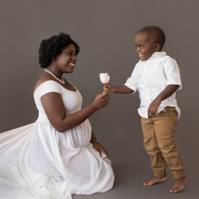 maternity portrait boy hands pink rose to mom for baby sister white chiffon maternity gown Gainesville FL