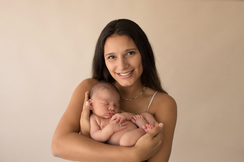 Gorgeous mom smiles and cuddles baby boy Gainesville FL