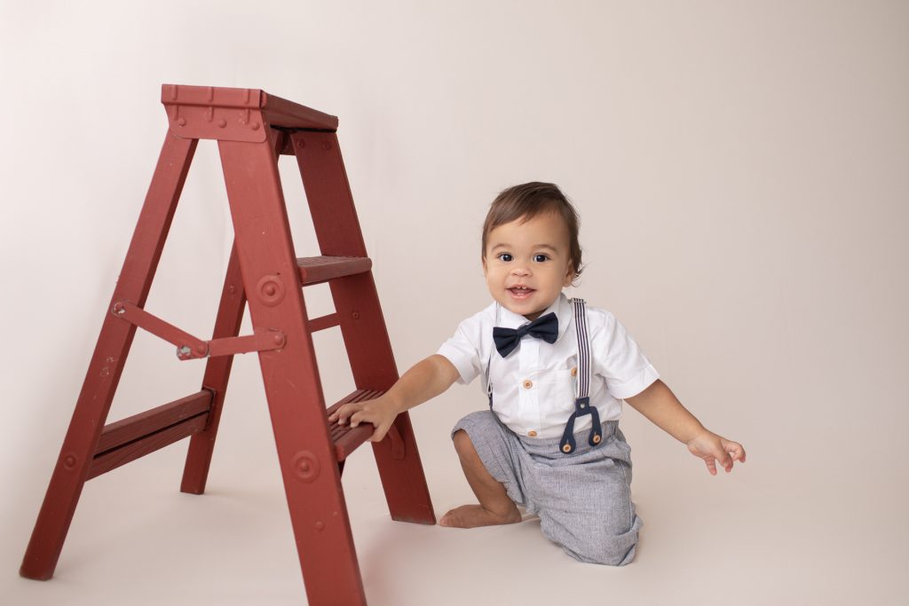 one year old with a ladder