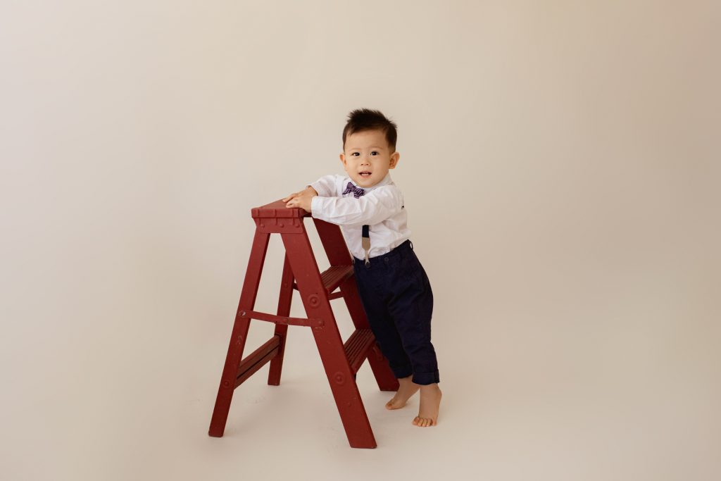 One Year Milestone Photos for Baby Boy Climbing and Exploring