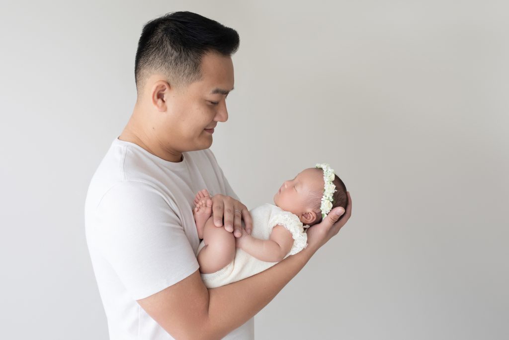 Newborn Baby Girl in Daddy's Arms