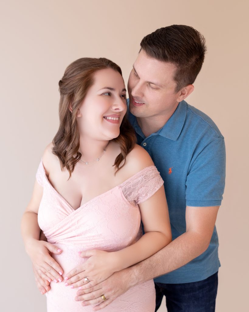 Young happy couple posing with baby shoes during gender reveal party  indoors Stock Photo - Alamy