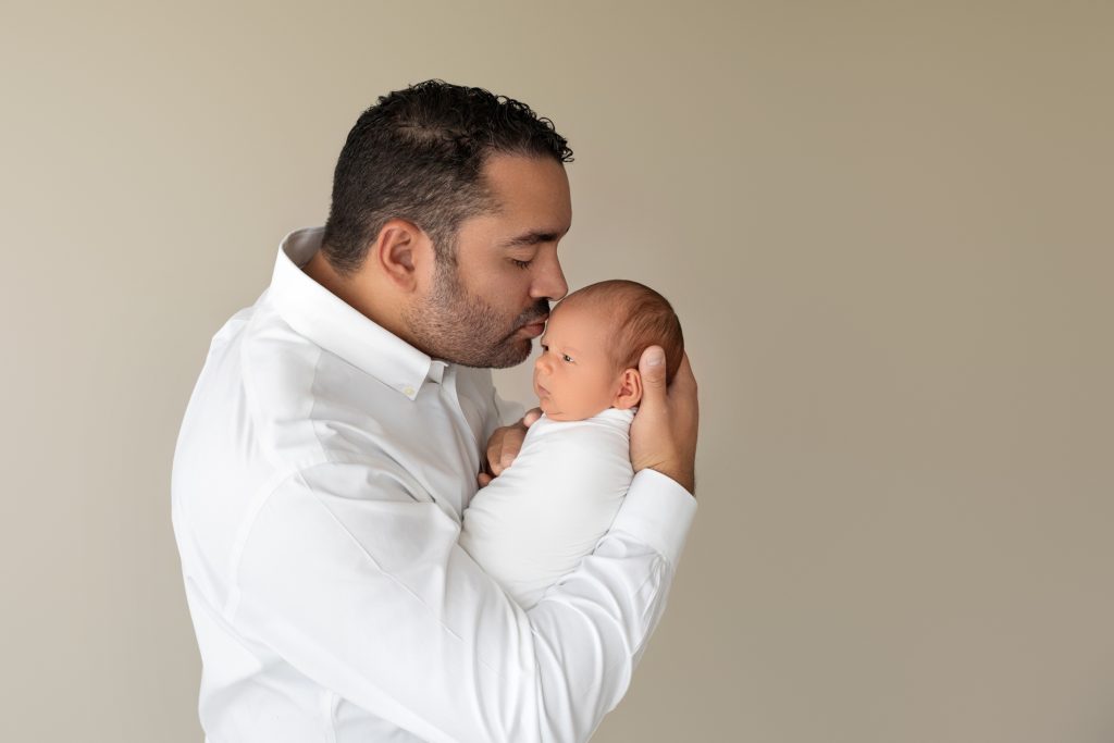 Dad Holds New Son in Newborn Photo Session in Gainesville, FL