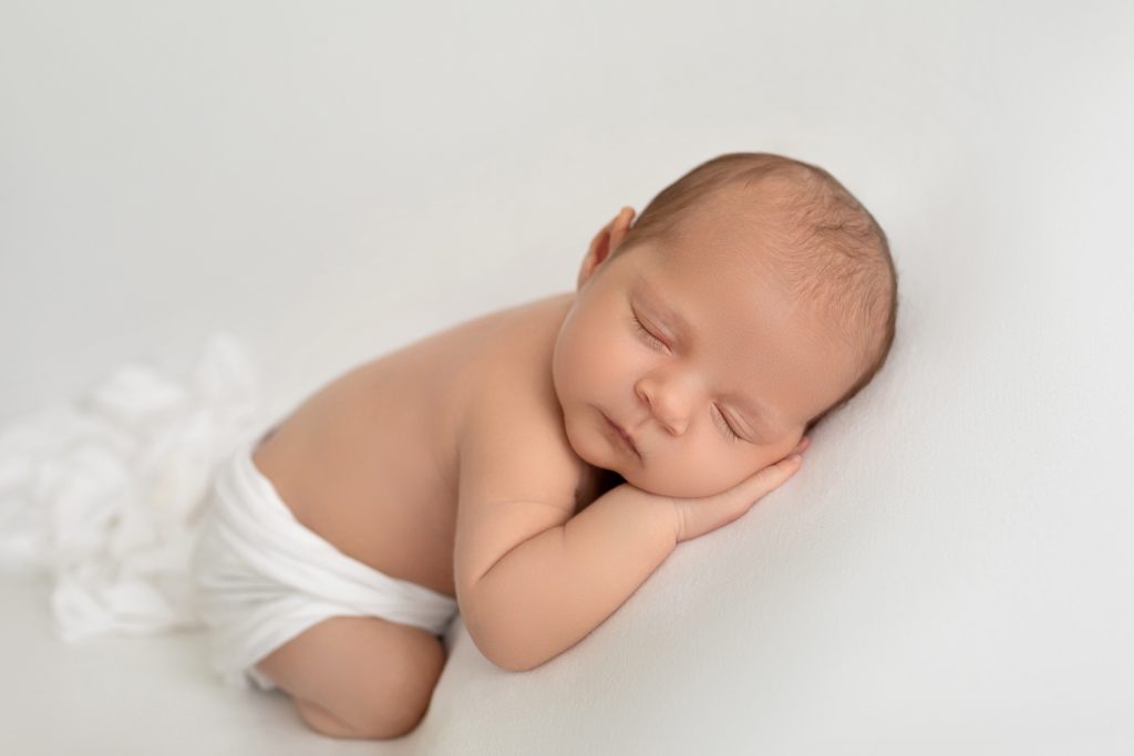 Newborn Baby Boy Asleep with Hand Under Cheek